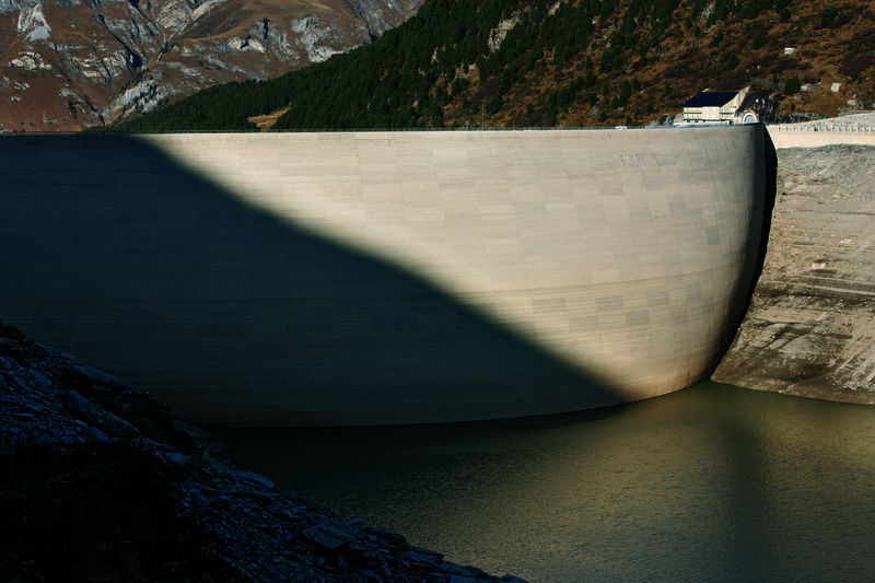 It's the Valle di Lei Reservoir and its arch dam (max. height 138 m, crown length 680 m). It holds 197 million m3 of water and is the third-largest reservoir in Switzerland. It is located for the most part in Italy and belongs to Kraftwerke Hinterrhein (KHR)